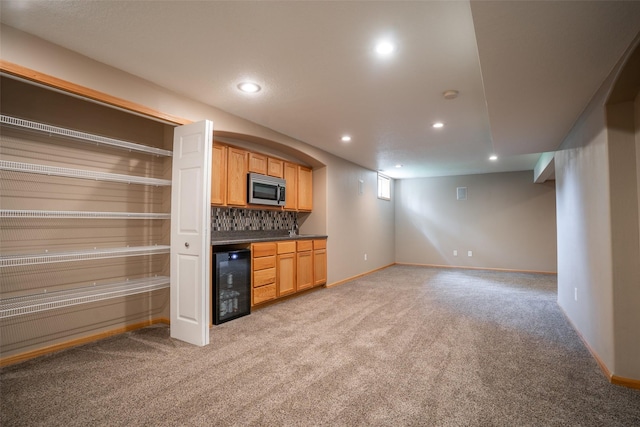 748 76th St, West Des Moines, IA 50266 - kitchen with wine cooler, stainless steel microwave, light carpet, dark countertops, and recessed lighting