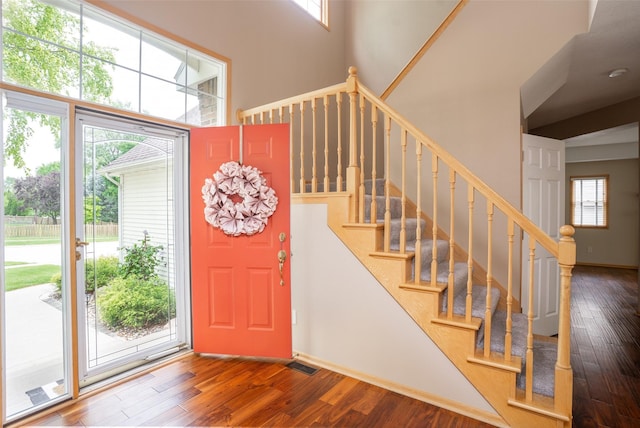 748 76th St, West Des Moines, IA 50266 - foyer featuring wood finished floors, healthy amount of natural light, stairs, and a towering ceiling