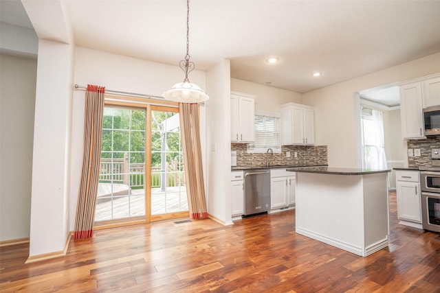 748 76th St, West Des Moines, IA 50266 - kitchen featuring appliances with stainless steel finishes, dark countertops, decorative backsplash, white cabinets, and recessed lighting