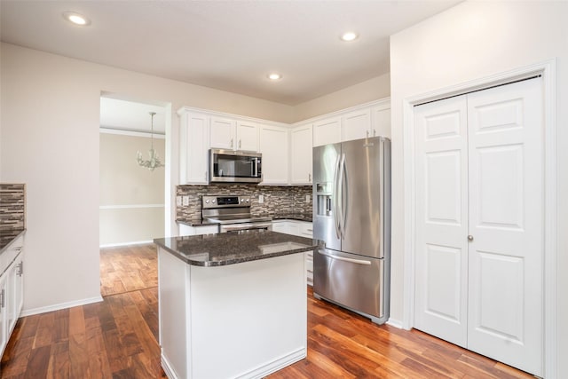 748 76th St, West Des Moines, IA 50266 - kitchen featuring appliances with stainless steel finishes, decorative backsplash, white cabinetry, and recessed lighting