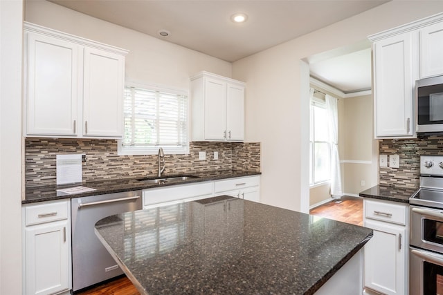 748 76th St, West Des Moines, IA 50266 - kitchen with appliances with stainless steel finishes, a sink, white cabinets, backsplash, and recessed lighting