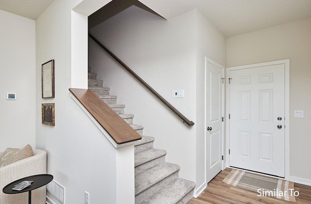 interior space with baseboards and wood finished floors