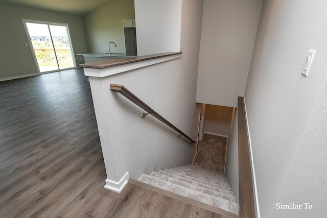 stairs with baseboards and wood finished floors
