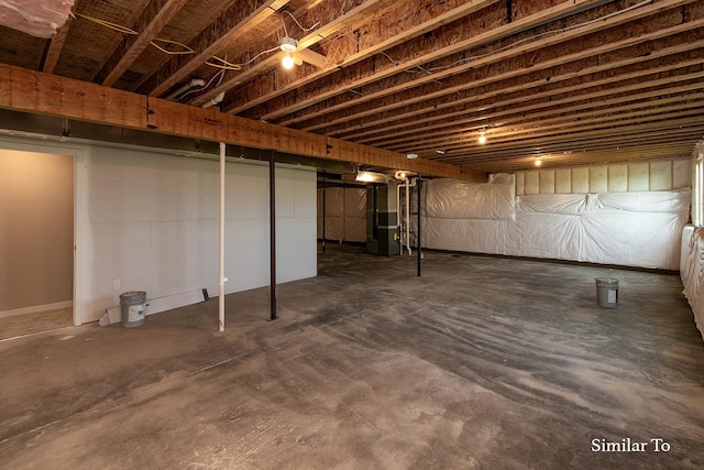 unfinished basement featuring heating unit