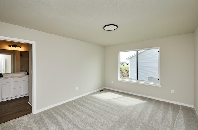 635 NW Compass Ave, Waukee, IA 50263 - unfurnished bedroom with dark colored carpet and connected bathroom