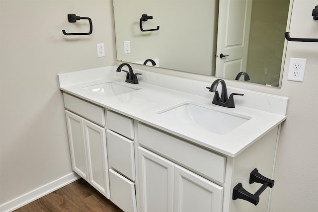 635 NW Compass Ave, Waukee, IA 50263 - bathroom featuring double vanity and wood finished floors