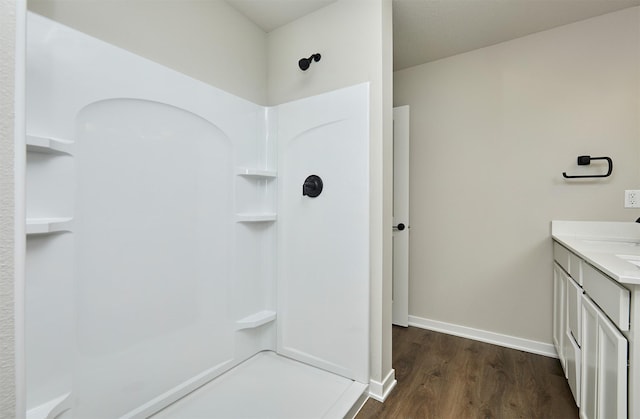 635 NW Compass Ave, Waukee, IA 50263 - bathroom featuring a shower, wood finished floors, and vanity