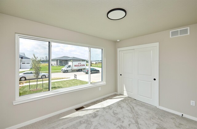 635 NW Compass Ave, Waukee, IA 50263 - unfurnished bedroom featuring carpet flooring and a closet