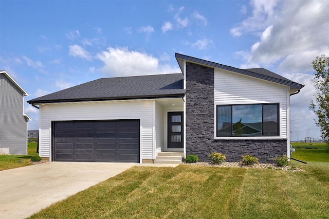 635 NW Compass Ave, Waukee, IA 50263 - view of front facade featuring a front lawn, concrete driveway, an attached garage, and stone siding