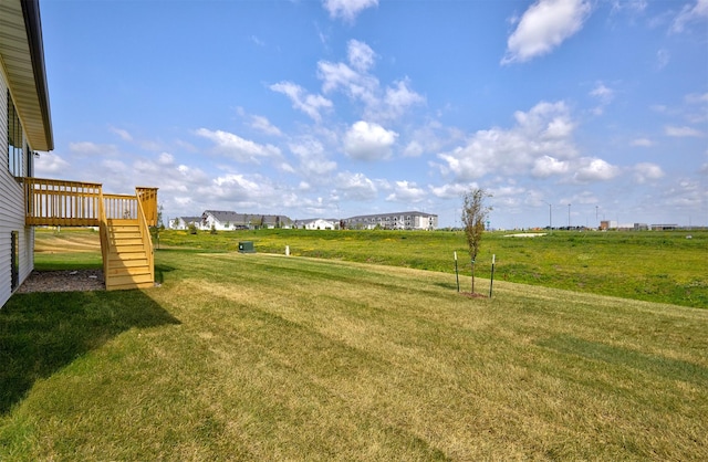 635 NW Compass Ave, Waukee, IA 50263 - view of grassy yard featuring stairway and a wooden deck