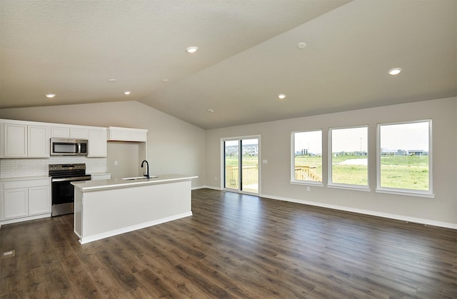 635 NW Compass Ave, Waukee, IA 50263 - kitchen featuring appliances with stainless steel finishes, vaulted ceiling, an island with sink, decorative backsplash, and open floor plan