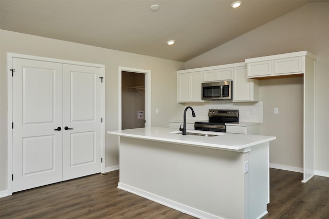 635 NW Compass Ave, Waukee, IA 50263 - kitchen with stainless steel appliances, lofted ceiling, tasteful backsplash, dark wood-type flooring, and white cabinets