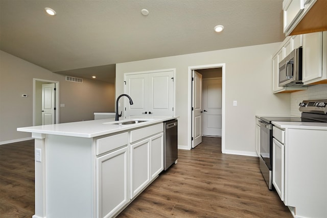 635 NW Compass Ave, Waukee, IA 50263 - kitchen with stainless steel appliances, dark wood-type flooring, an island with sink, decorative backsplash, and recessed lighting