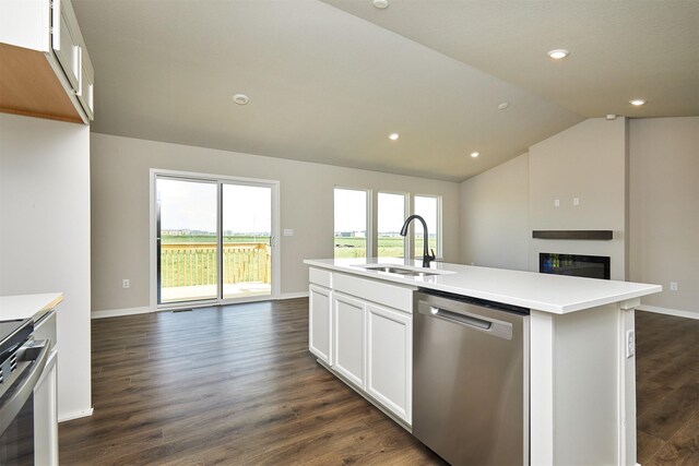 635 NW Compass Ave, Waukee, IA 50263 - kitchen with dishwasher, open floor plan, range, a glass covered fireplace, and lofted ceiling