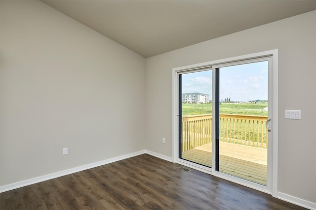 635 NW Compass Ave, Waukee, IA 50263 - spare room featuring dark wood-style flooring and vaulted ceiling