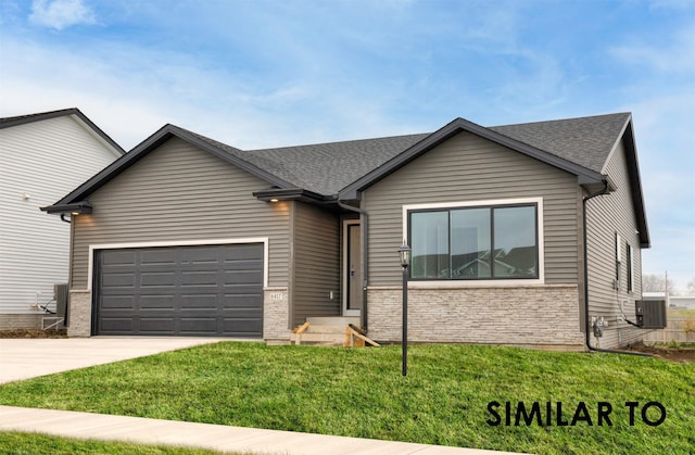 5539 167th St, Urbandale, IA 50323 - view of front of home with driveway, an attached garage, stone siding, roof with shingles, and a front yard