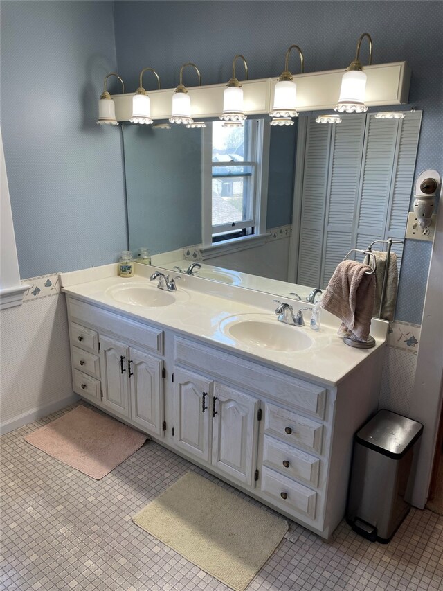 full bathroom featuring a sink and double vanity