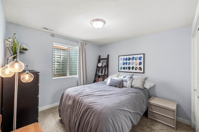 bedroom featuring a textured ceiling, carpet floors, visible vents, and baseboards