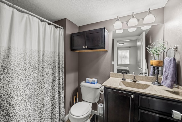 full bath with curtained shower, vanity, a textured ceiling, and toilet