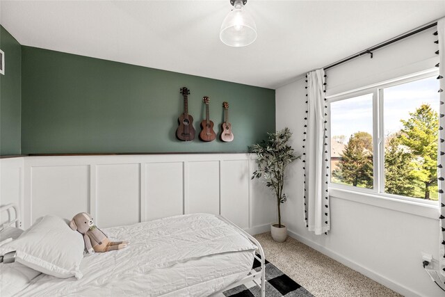 carpeted bedroom with wainscoting