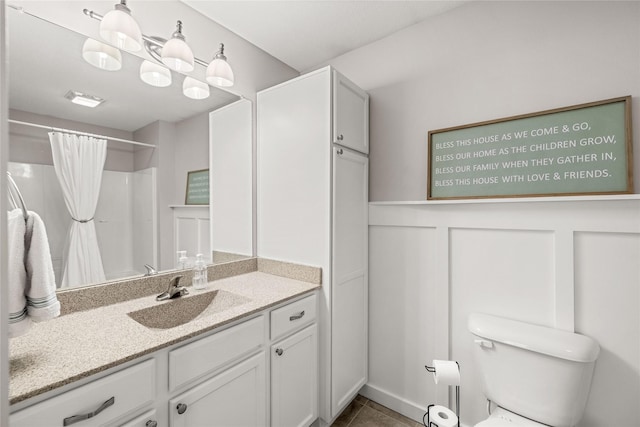 bathroom with tile patterned flooring, toilet, vanity, and a shower with curtain