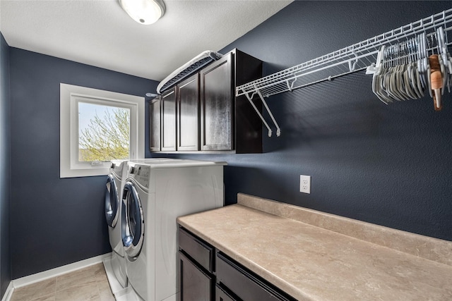 laundry room with separate washer and dryer, baseboards, and cabinet space