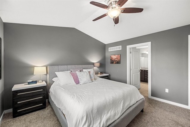 carpeted bedroom with baseboards, visible vents, lofted ceiling, a ceiling fan, and connected bathroom