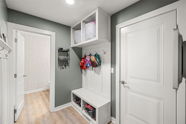 mudroom with light wood-style floors and baseboards