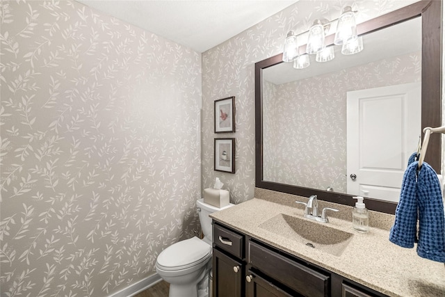 half bath with wood finished floors, toilet, and vanity
