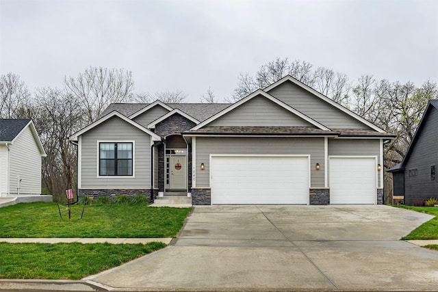 1040 W Trace Pl, Polk City, IA 50226 - view of front of home with a front lawn, stone siding, concrete driveway, an attached garage, and a shingled roof