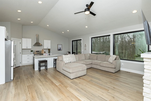1040 W Trace Pl, Polk City, IA 50226 - living area featuring vaulted ceiling, light wood-style floors, and recessed lighting
