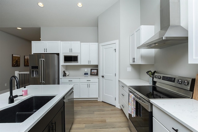 1040 W Trace Pl, Polk City, IA 50226 - kitchen featuring white cabinets, stainless steel appliances, a sink, and wall chimney range hood