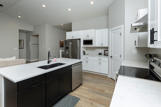 1040 W Trace Pl, Polk City, IA 50226 - kitchen featuring an island with sink, under cabinet range hood, stainless steel appliances, a sink, and light wood-style floors