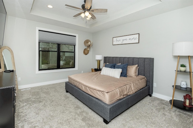 1040 W Trace Pl, Polk City, IA 50226 - carpeted bedroom featuring a ceiling fan, a tray ceiling, baseboards, visible vents, and recessed lighting