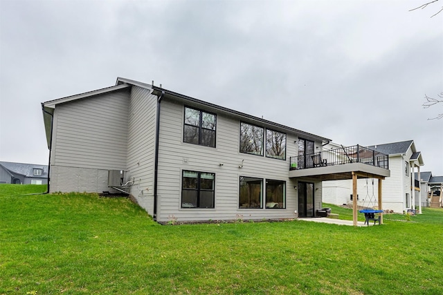 1040 W Trace Pl, Polk City, IA 50226 - back of property with a lawn, a patio, and a deck