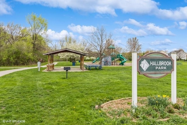 view of home's community featuring a lawn and playground community