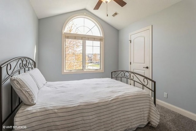 carpeted bedroom featuring lofted ceiling, visible vents, a ceiling fan, and baseboards