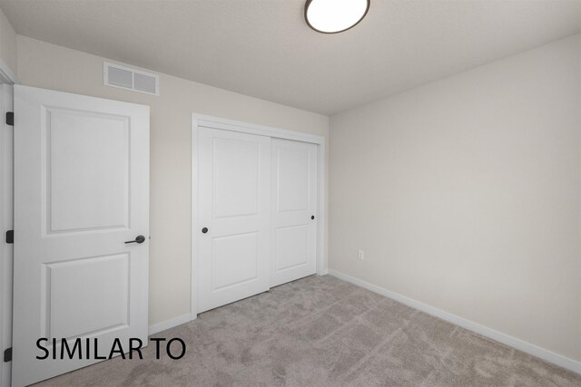 16514 Ironwood Ln, Urbandale, IA 50323 - unfurnished bedroom with carpet, baseboards, and a closet