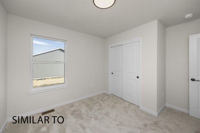 16514 Ironwood Ln, Urbandale, IA 50323 - unfurnished bedroom featuring carpet, multiple windows, a closet, and baseboards