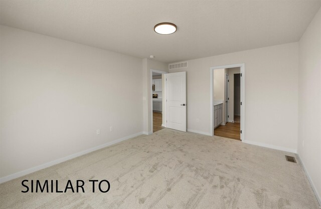 16514 Ironwood Ln, Urbandale, IA 50323 - unfurnished bedroom with carpet, baseboards, and connected bathroom