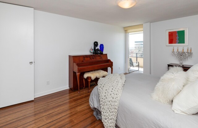 3663 Grand Ave Unit 905, Des Moines, IA 50312 - bedroom featuring baseboards and wood finished floors