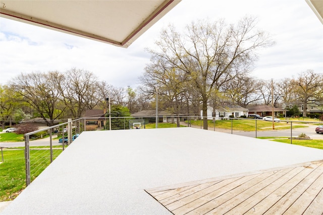 exterior space with a residential view and a lawn
