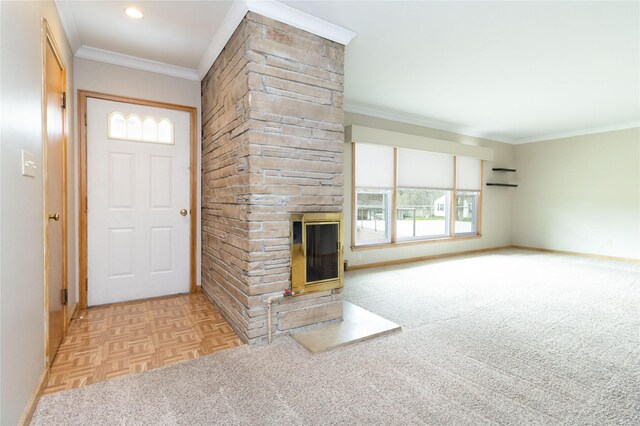 entrance foyer featuring baseboards, a stone fireplace, and ornamental molding