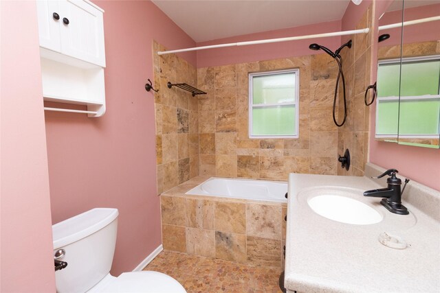 full bath with toilet, a wealth of natural light, tiled shower / bath combo, and vanity