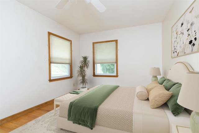 bedroom featuring baseboards, ceiling fan, and wood finished floors