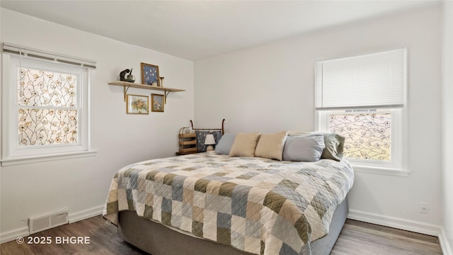 2318 56th St, Des Moines, IA 50310 - bedroom featuring baseboards, wood finished floors, and visible vents