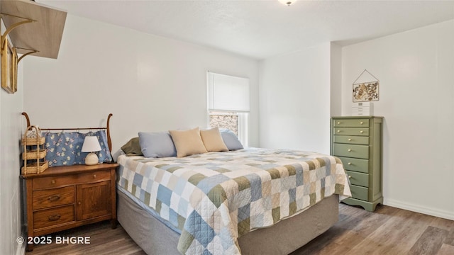 2318 56th St, Des Moines, IA 50310 - bedroom featuring baseboards and wood finished floors