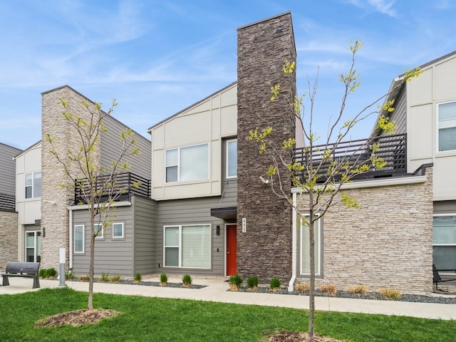 455 SW 12th St, Des Moines, IA 50309 - modern home with a front yard and stone siding