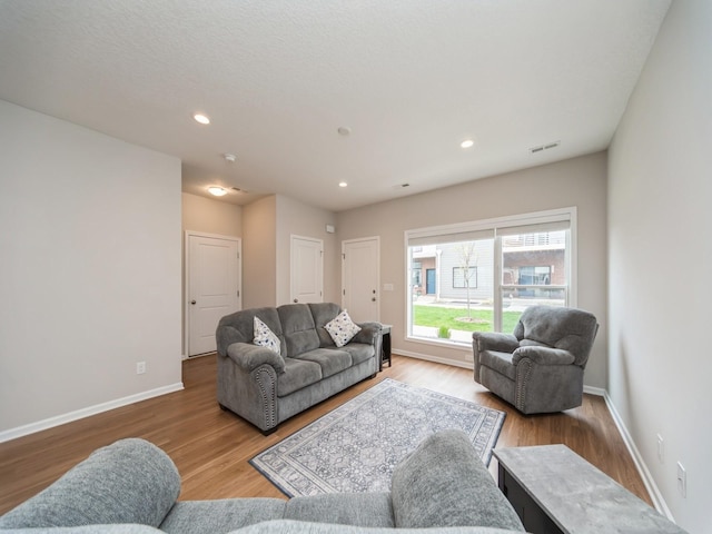 455 SW 12th St, Des Moines, IA 50309 - living area with recessed lighting, visible vents, wood finished floors, and baseboards