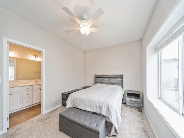 455 SW 12th St, Des Moines, IA 50309 - bedroom with light colored carpet, a sink, baseboards, and multiple windows